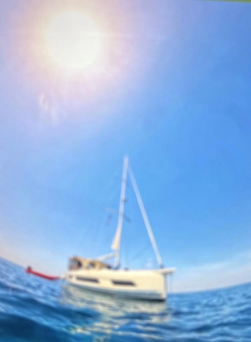 Sailing yacht at anchor on open water